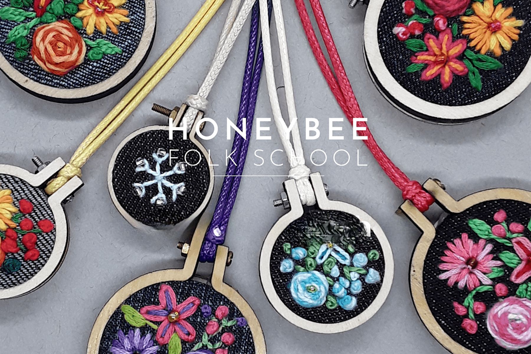 A collection of embroidered necklaces, some with floral patterns on them.